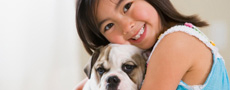 A child hugging a dog