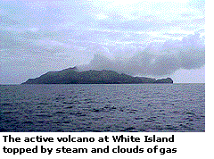 The active volcano at White Island topped by steam and clouds of gas