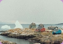 Iceberg off rocky coastline, coastal erosion